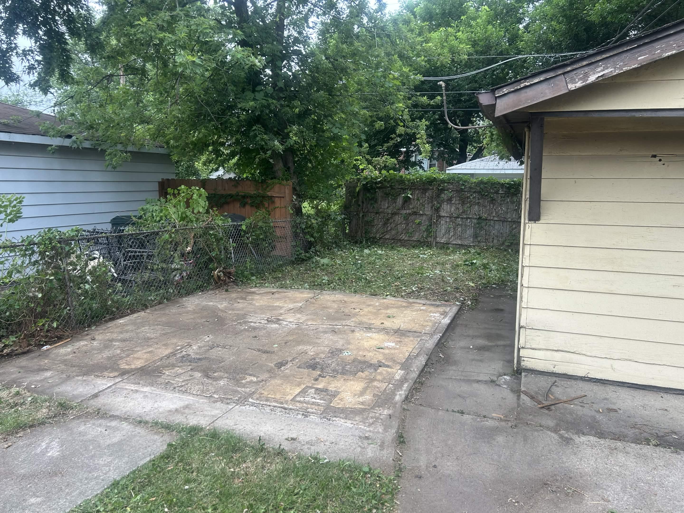 Backyard patio cleared of the shed and debris after demolition